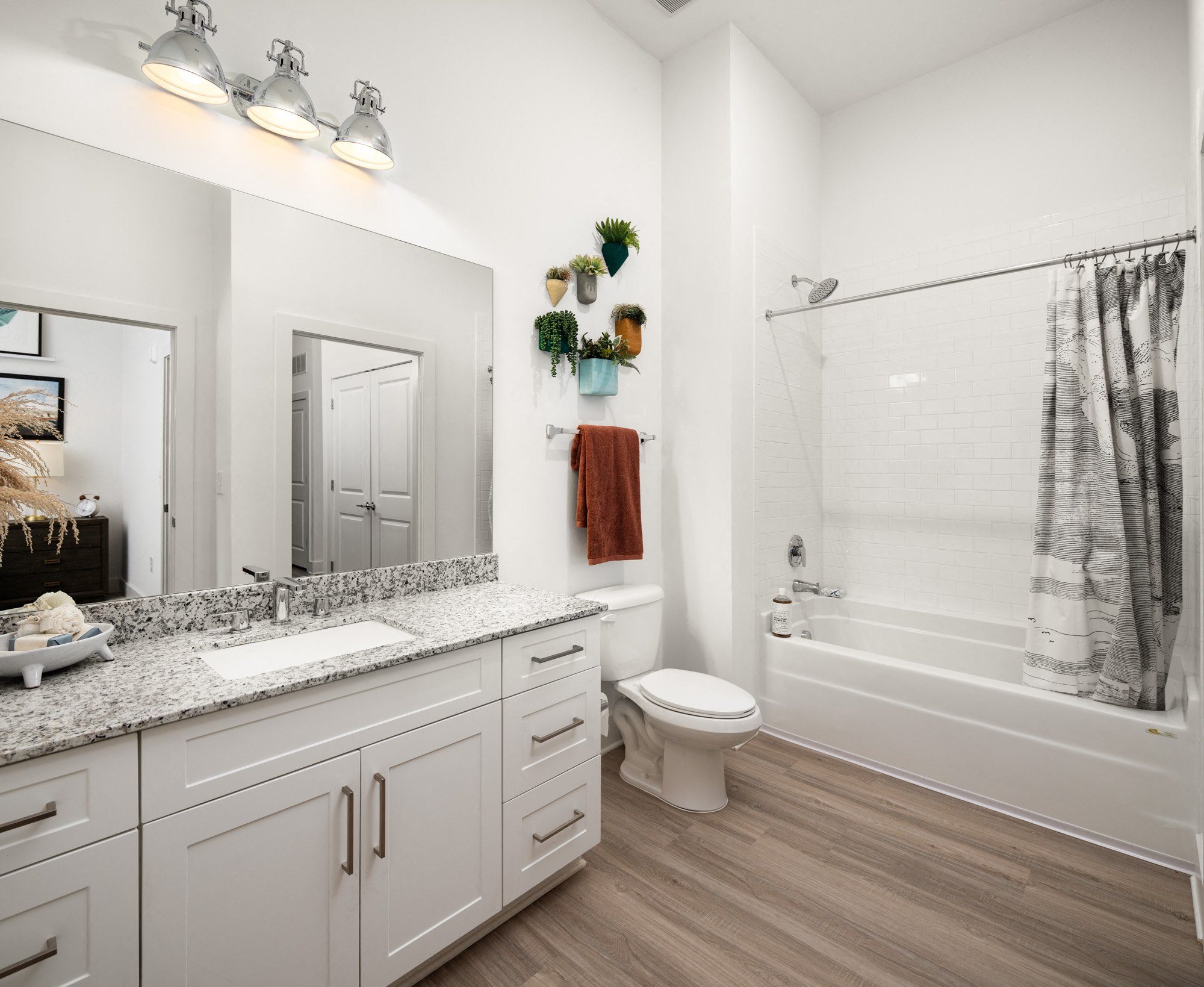 a bathroom with a shower toilet and sink and a mirror